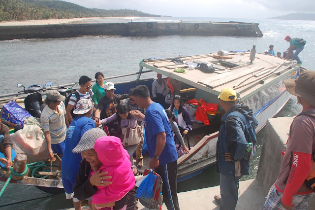 Passengers alight from a Faluwa (boat) at the Ivana port coming from Sabtang Island in Batanes