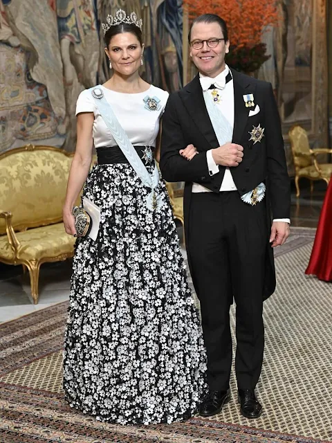 Crown Princess Victoria is wearing Camilla Thulin floral skirt and Connaught tiara. Princess Sofia is wearing Ida Lanto red gown