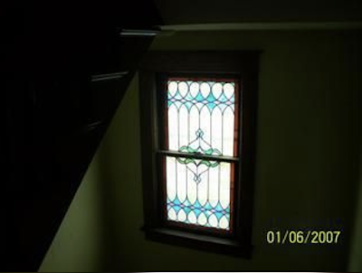 color photo of stained-glass window in staircase of Sears No 137, 40 4th Street, Canisteo, New York