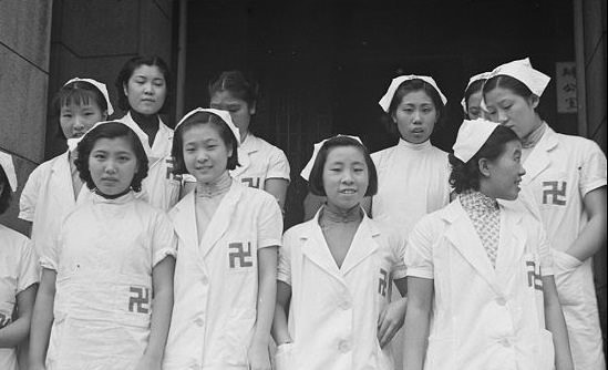 Chinese edical staff wearing swastika armbands.