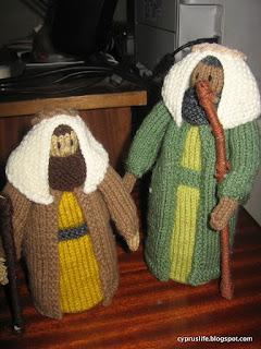 two shepherds from the knitted nativity, one rather shorter than the other