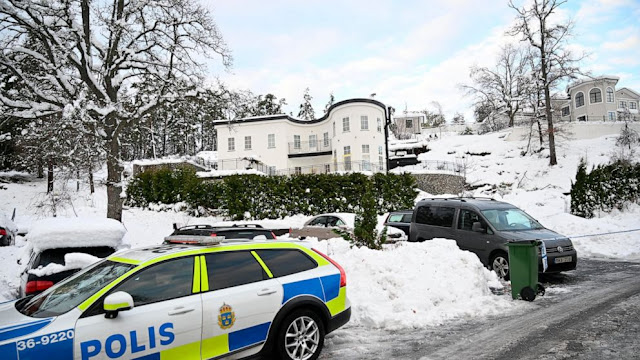 A police car is parked outside a house where the Swedish Security Service allegedly arrested two people on suspicions of espionage in a predawn operation in Stockholm, Tuesday, Nov. 22 2022.
