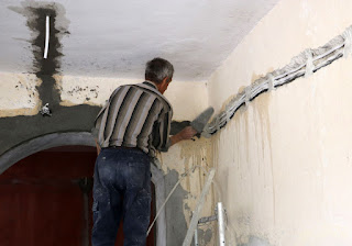 Sally chases Bekir around the walls with cement