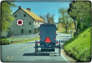 stone house with amish buggy barn quilt