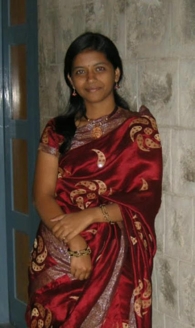 A Beautiful Telugu girl in saree at a Temple deity. 