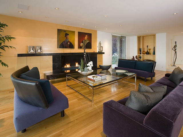 Picture of dark modern furniture by the fireplace and wooden wall in the living room