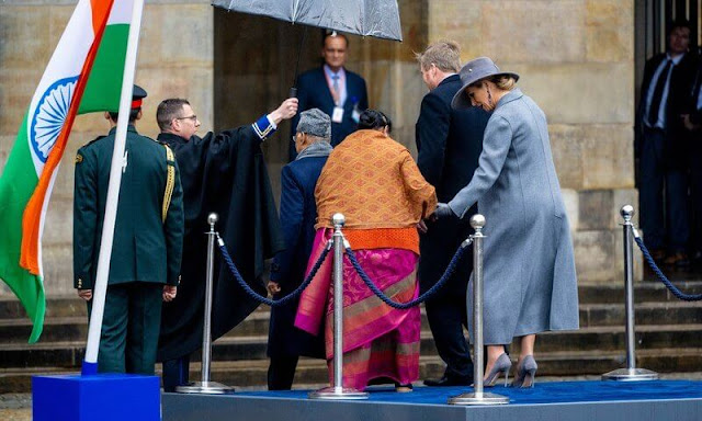 Queen Maxima wore a purple puffled-sleeves dolman midi dress from Victoria Beckham. President Ram Nath Kovind and Savita Kovind