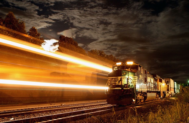 Train crosses Kemper Street, Lynchburg, Virginia, USA during a nearly full moon. 