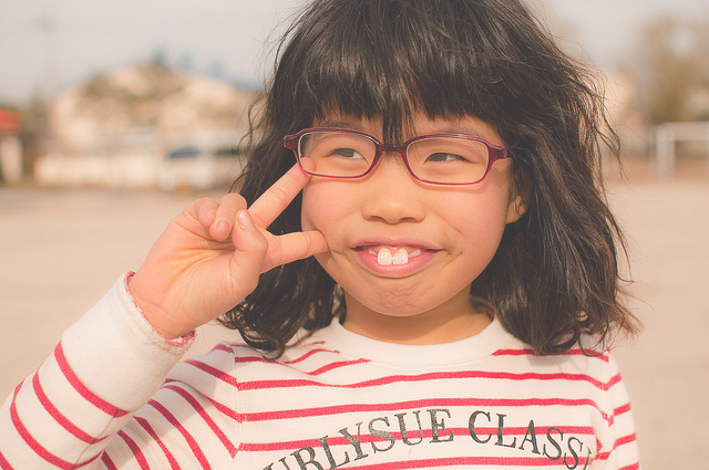 chubby asian girl with rabbit teeth and red stripes jumpers isn't it 