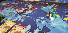 Pandemic gameplay board layout with pieces pawns and cards