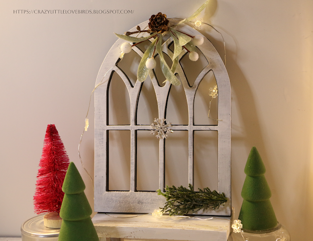 faux arched window frame winter design displayed with lights and mini trees