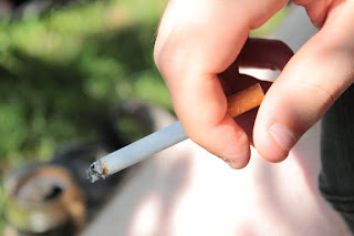 Image of cigarette and a hand