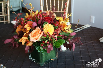 Fall wedding centerpiece, orange and maroon centerpiece, orange mokara orchids, red hypericum berries, orange roses