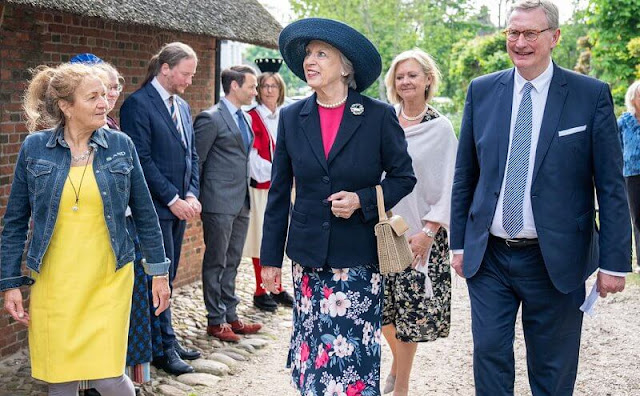 Princess Benedikte wore a black blazer and floral print skirt, and green cashmere cape. Princess Benedikte visited Old Frisian House
