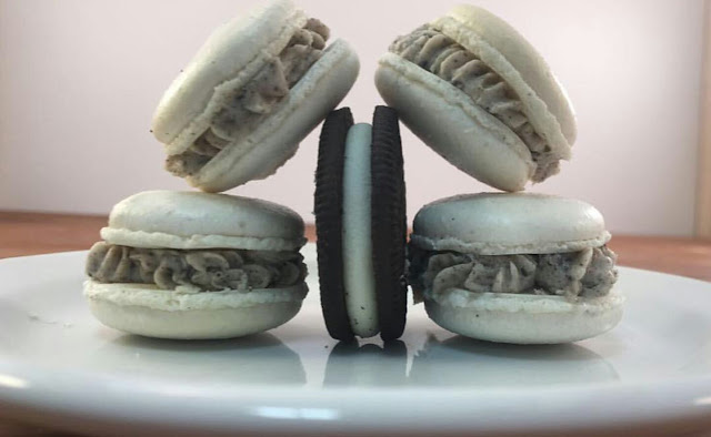 Cookies & Cream Macarons on a white plate with an oreo in the middle