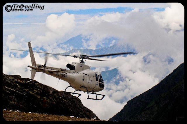 Helicopter ride to Mani Mahesh Lake in Chamba District of Himachal Pradesh, INDIA : Posted by Vishal Sharma on www.travellingcamera.com : The name Manimahesh signifies a jewel (Mani) on Lord Shiva's (Mahesh'es) crown.... Local people claim that the moon-rays reflected from the jewel can be seen from Manimahesh Lake on clear full-moon nights (which is a rare occasion)... It is more likely to be the light reflected from the glacier , like a serpent on Shiva's neck...The Helicopter flies from Bharmour Helipad or Chamba depending upon the reservation you have... and then reaches up to Gauri Kund... From Gauri Kund onwards you have to continue next 1 km on foot and then after Darshan you will have to came back to catch the flight from Gauri Kund to Bharmour Helipad/Chamba... The both way Ticket for Manimahesh Yatra is also available with us. The both way ticket will cost you 8600.00 INR per passenger from Bharmour to Gauri Kund and 14500.00 INR from Chamba to Gourikund up and Down...The route to Manimahesh is via Chamba, Himachal Pradesh, Bharmour and Hadsar. Motorable road goes till Hadsar. The rest of the path is to be covered on foot, about 13 km of steep climb by the banks of Manimahesh Ganga, which originates from the Manimahesh Kailash peak. During the annual pilgrimage in August - September, numerous night-shelters and eateries spring up by the trekking route. Night-shelter is also available at village Dhancho, about 6 km from Hadsar on the way to Manimahesh, round the year. Another less frequented trekking route originates from Holi, which is connected to Chamba...Helicopter flying in Pir Panjal Moutain ranges of Himalyas...Helipad @ Gauri Kund, Manimahesh, Chamba, Himachal Pradesh...Manimahesh Lake (also known as Dal Lake, Manimahesh), situated in the Pir Panjal Range of the Himalayas, is a high altitude lake (el. 4080 m.). The Manimahesh Kailash peak that stands high close to the lake is believed to be the abode of Lord Shiva... This place is believed to be second to the Lake Manasarovar in its religious significance....