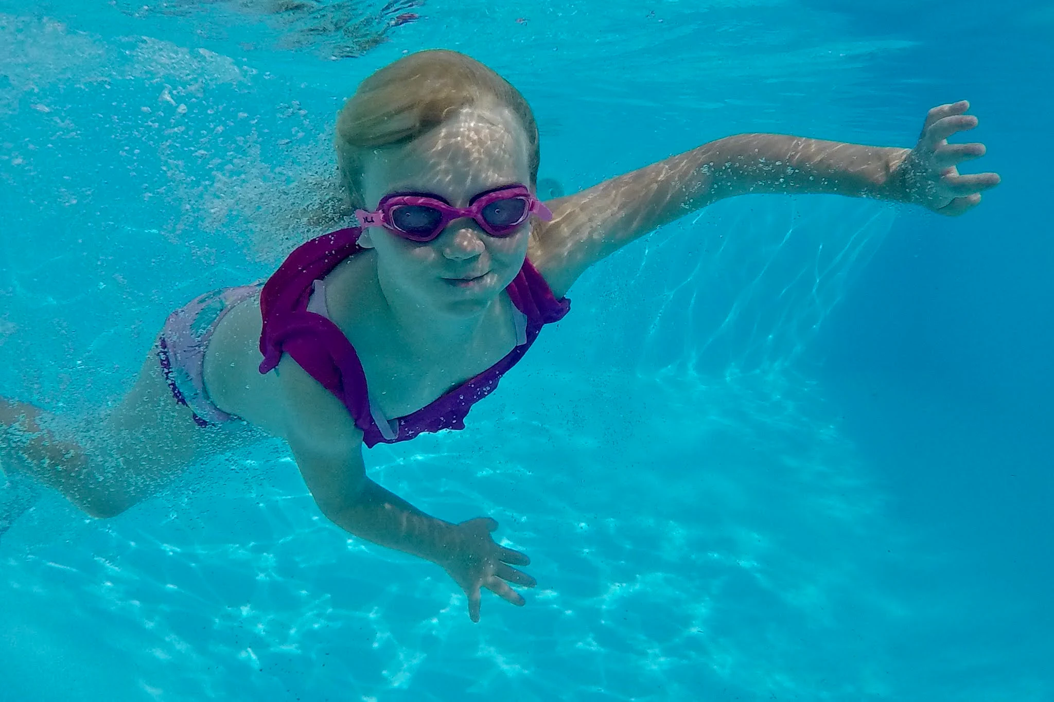 A child swimming under water in an indoor Essex swimming pool