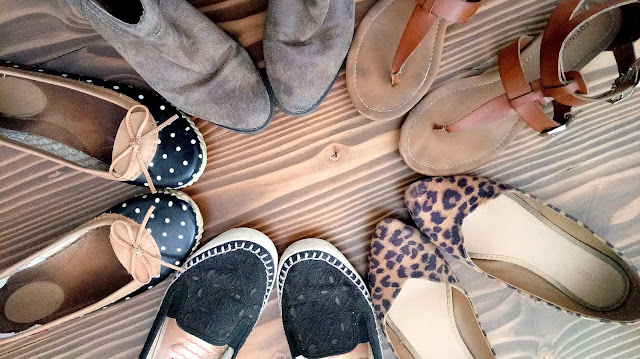 a pair of boots, leopard flats, polka dot flats, black embroidered slip ons, and brown sandals in a circle