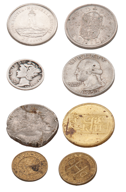 A series of old coins and tokens.