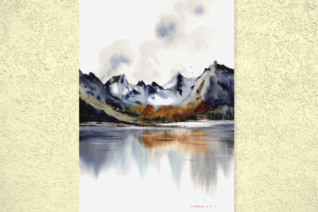 A lovely watercolor landscape painting of a mountain lake with autumn trees and a cloudy sky all reflecting on the water by artist Eugenia Gorbacheva