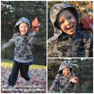 child playing in beautiful fall leaves