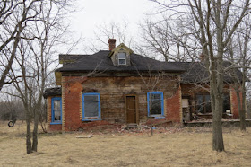 dilapidated brick house with quoins