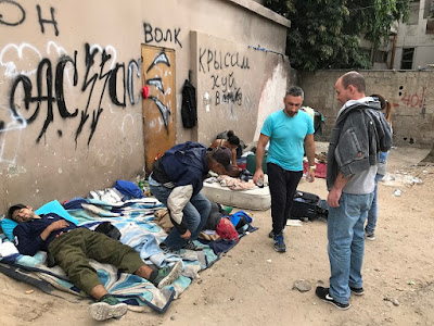 Homeless resting outside of Tel Aviv's Homeless Cafe