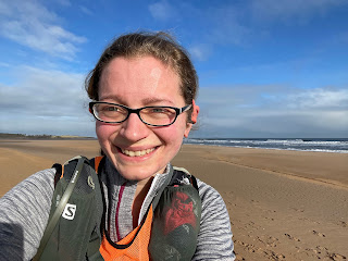 A selfie of me smiling at the beach.