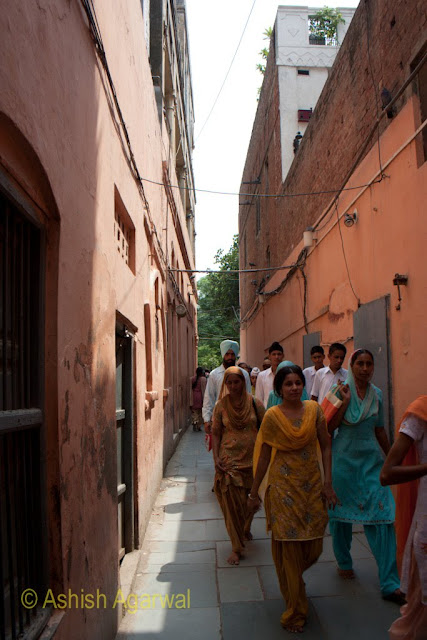 People walking out in a sombre mood after visiting the Jallianwala Bagh memorial in Amritsar