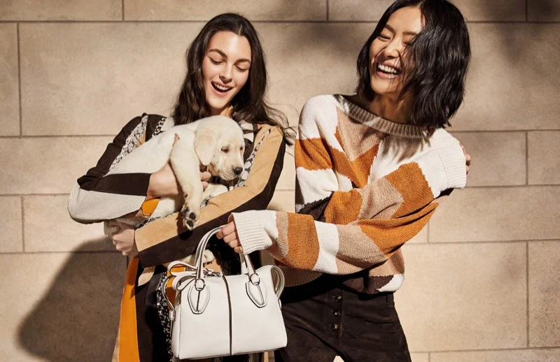 Liu Wen and Vittoria Ceretti pose with a dog on set of Tod’s spring 2019 photoshoot