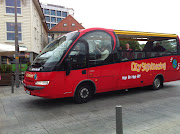 This city sightseeing bus is driving around the city center. (img )