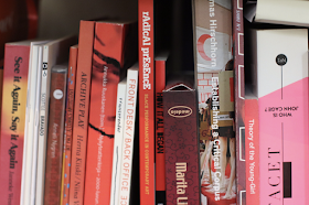 An image of art-related books ordered by color (red)