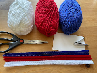 Supplies for crafting a patriotic yarn garland for 4th of July celebrations