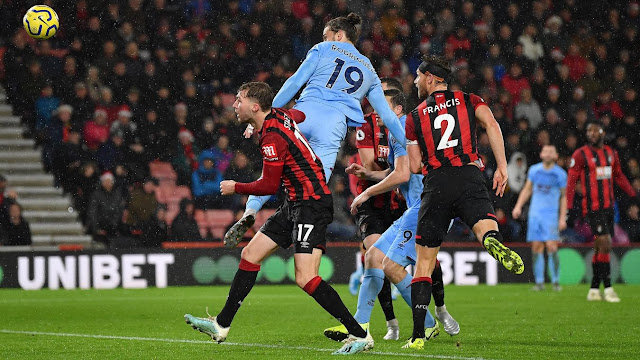Burnley forward Rodriguez beats two Bournemouth defenders to a header during a Premier League match