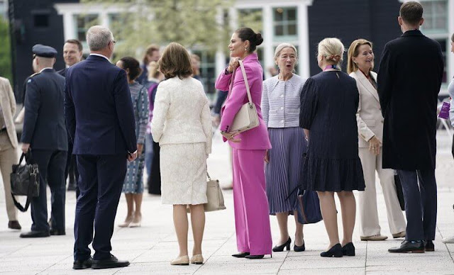 Silvia and Victoria attended the opening of H22 City Expo. Crown Princess Victoria wore a one button blazer suit pink fuchsia
