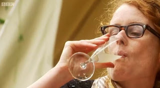 Alys drinks a glass of homemade elderflower champagne