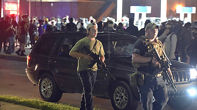 Kenosha shooter Kyle Rittenhouse, at left, and his fellow militia member Ryan Balch, walk along Sheridan Road in Kenosha, Wisconsin, on the fatal night.