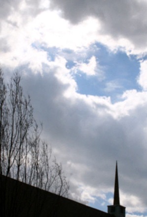 FUMC-41-7-Spire-pointing-to-blue-sky-surrounded-by-storm-clouds-744280