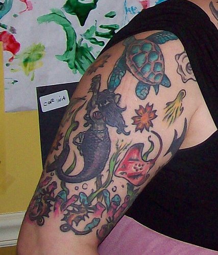 Marine mermaid and tortoiseupper arm tattoo