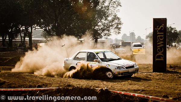 Last week, a motorsport event took place in Mohali (Near Chandigarh), which was organized by OYA Auto Cross and Motorcross. JK Tyre was one of the main sponsor of this event and it continued for three days. During final day I also visited the ground to bring this PHOTO JOURNEY for you. Let's check it out...Cars were literally flying on this ground and whole region was full of dust only. At times it was difficult to see these moving cars. It was hard to imagine that we were standing on a ground which is not in states like Rajasthan. The only word was coming to my mind at that point of time - Dust-Storm, like the one happens in Rajasthan; 'Desert Storm'... Let's check out more photographs from this series of Dust-Storm in Chandigarh...Different types of Cars and Bikes participated in this event, but cars competitions were mainly compelling us to rename it as 'Dust Storm'. Only two cars at a time were enough to cover sky with dust.I am not sure what this 'Dewars' was, but various pillars were planted on this ground. These should be some brands who supported this motorsport event. Barista was also there to serve snacks and drinks, but not sure if they were sponsors or not.Different cars by Honda, Maruti, Mitsubishi & Toyota participated in this event. At times, it was hard to believe that some specific cars can fly like this... One of the rider was very well controlling a white Swift, and it was competing with a 4 by 4 Jypsy...These cars were making the ground-dust to fly in air and at times, they used to cover themselves by dust storms. Specifically, there was huge dust on taking any turn.A colorful Maruti Car going down into a tunnel which was created artificially on this ground for Motorcross competitions during 3rd OYA sports-event.Passion of all these riders was commendable and it was hard to imagine that human beings were driving these super-machines.'Dust Storm' is something coined on run-time and not related to this event.I tried to check about this event on FMSCI website but couldn't find any details. Website of OYA was not much helpful for me to get information as non-motorsport person. Anyway, please have a loo at following link to know more about the organization which organized this event in Mohali - http://oyamohali.comWhole ground was surrounded by lot of people who wanted to see these races, but unfortunately the dust was biggest enemy. After one lap of car racing, there was nothing visible on ground. So everyone was more excited about bike racing, which had more participants at one point of time and things were visible as least.Motrosports in India is one of the increasing passion among people in cities like chadigarh. Now India is also getting some powerful machines, which was not that easy few years back. But still lot of folks can't afford these powerful machines without sponsorship and in such competitions, it's not easy thing to compete with imported machines with our usual bikes.Another shot where another car is contributing to Dust Storm on this ground in Mohali, Punjab, INDIA...After lot of dust in above photographs, I also thought of sharing some bike photographs to show another side of the PHOTO JOURNEY...It seems that bikers in such competitions also use their legs as supporting equipment while turning these machines on extremely high speed.With this, let me finish this Photo Journey of Dust Storm in Chandigarh (Mohali, Punjab)