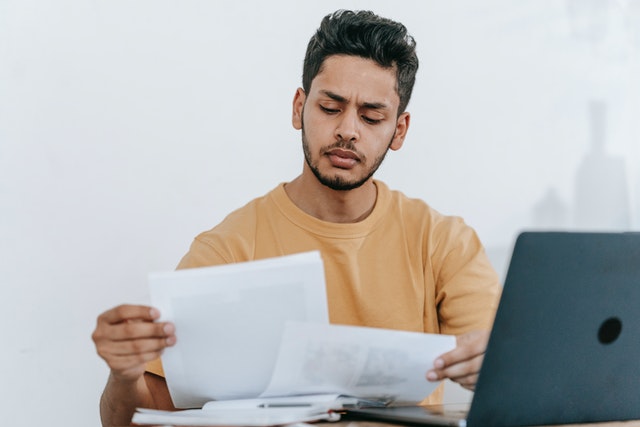 designer looking at multiple design revision briefs