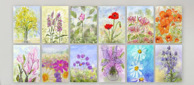 A photo of 12 colourful floral prints, printed on metal and hung on a wall in a 6 by 2 grid.