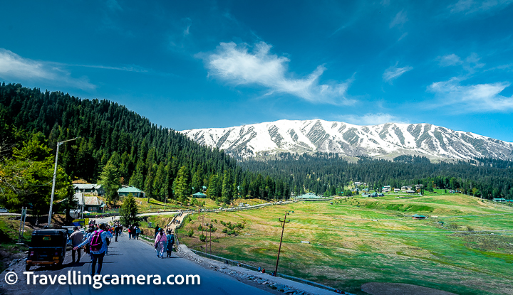 The Huge Green Meadow around Taxi Stand and main market of Gulmarg :  Unfortunately most of the folks pass by this green land in the middle of mountains full of deodars and head towards Gandola base & places beyond the places where Gandola drops. Above photograph gives a glimpse of these meadows on the right. Now since there are no trees, it may get hard to sit around this place on a sunny day during summers. During winters this place is full of snow and hence snow activities. In Summers, one can walk around the outer circle of this meadow which will be huge. In above photograph you see meadow on the right and on the left you see deodars. Why not get inside the forest and spend time enjoying the nature and beautiful weather of Gulmarg. Carry some stuff for the picnic and you can find a nice place inside the deodar forest. If you enjoy pony rides, you can take a round around this green meadow of Gulmarg.