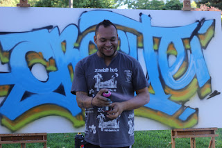 Graffiti Artist AC using Sea blue, Midnight blue, olive and burnt orange.