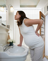 pregnant women pose at mirror