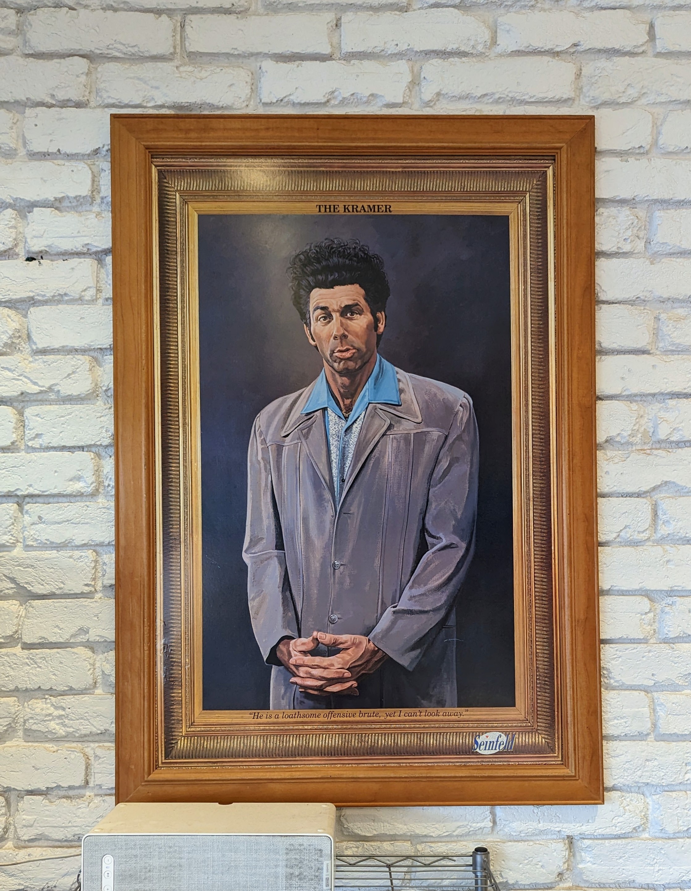 'The Kramer' framed painting on a white café wall
