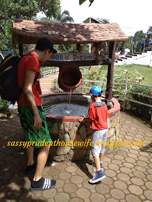 father-and-son-at-ginger-bread-house-wishing-well