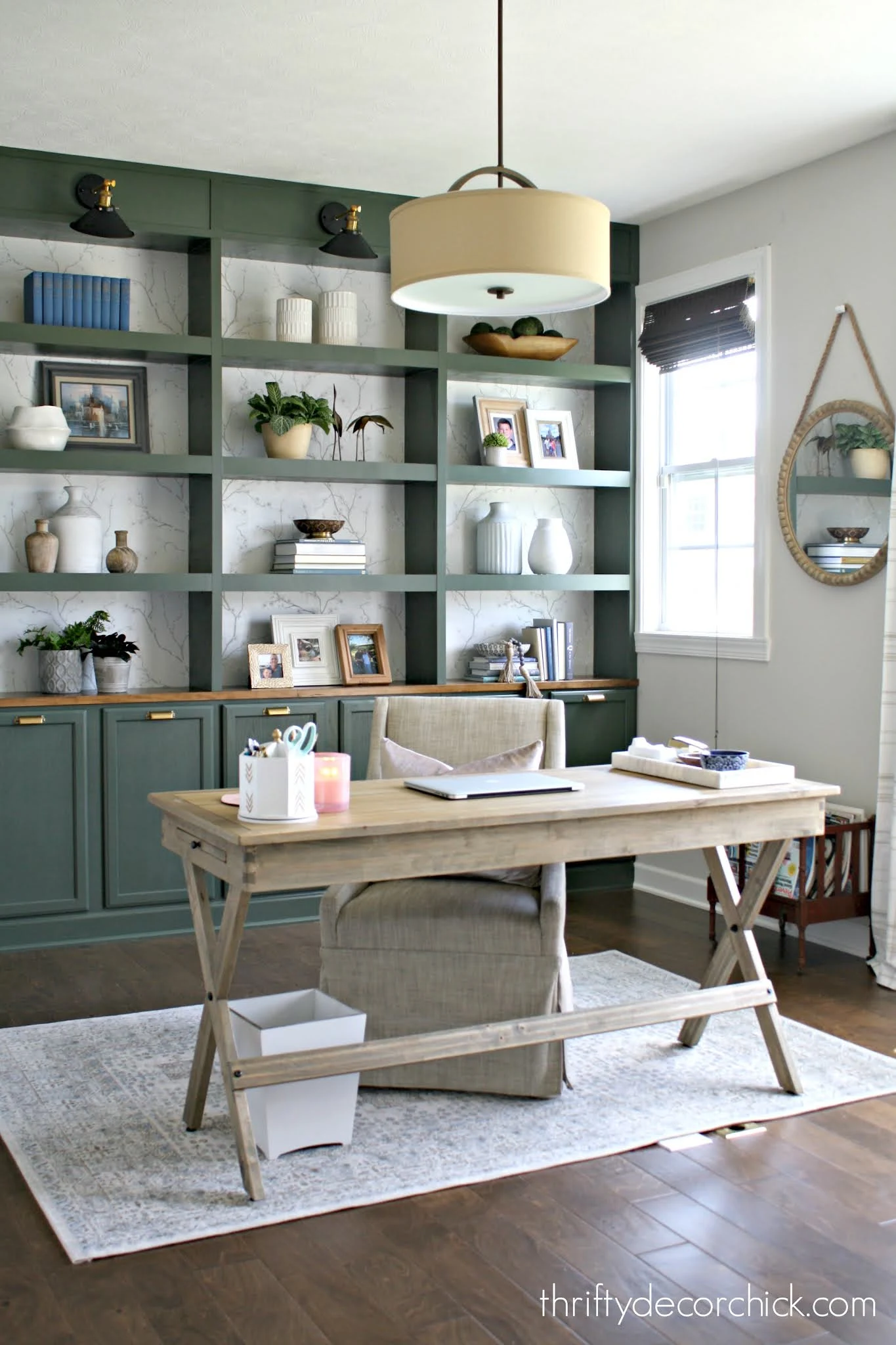 green bookcases with desk