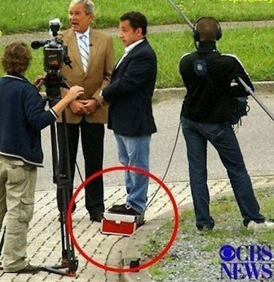 Nicolas Sarkozy standing on a box