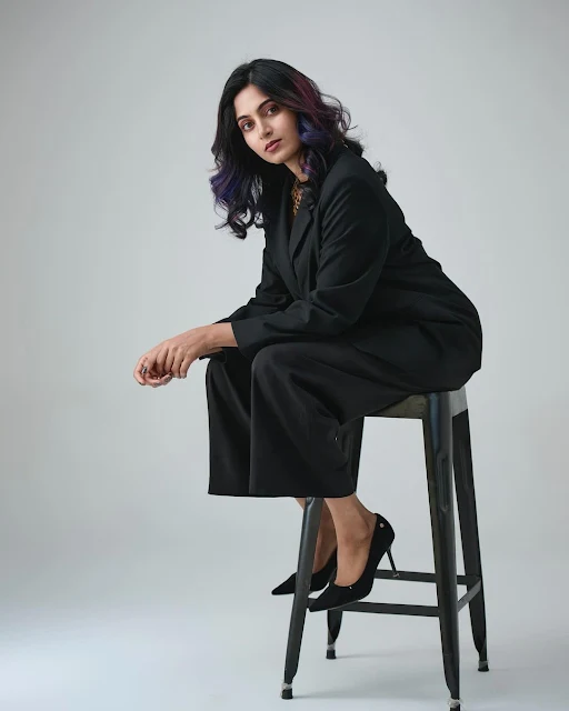 Kushee Ravi posing in black suit